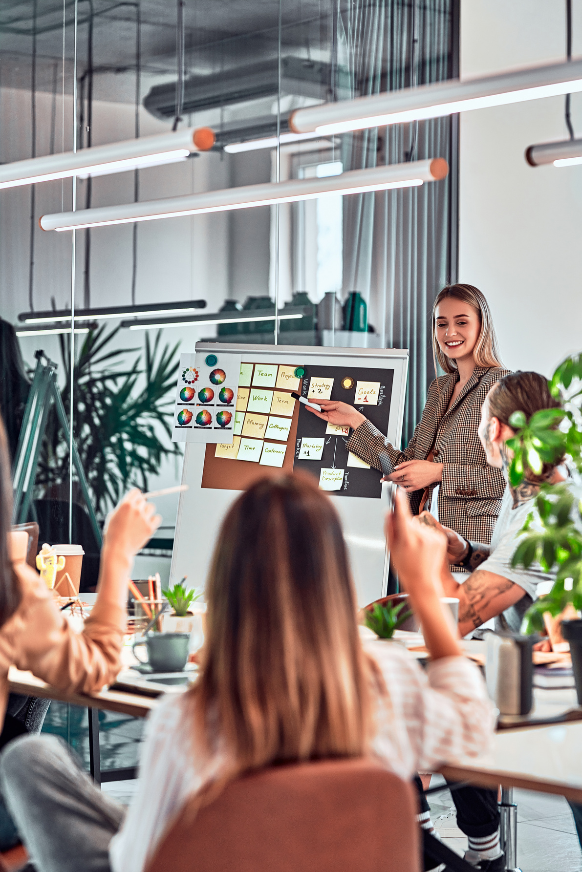 Group of positive multicultural marketing experts planning working process and sharing ideas while creating advertising campaign.